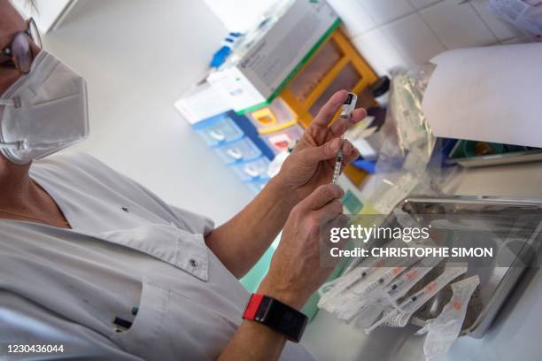 Health worker prepares a syringe to administer the Pfizer-BioNTech Covid-19 vaccine at the Timone Hospital in Marseille, southeastern France, on...