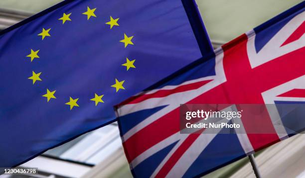 European Union and Great Britain flags are seen on the building in Krakow, Poland on January 5, 2020.