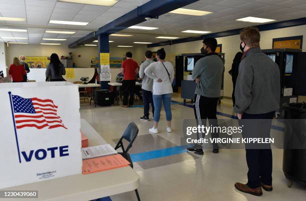 Voters go to the polls at Sara Smith Elementary polling station, in the Buckhead district, on January 5, 2021 in Atlanta during the Georgia Senate...