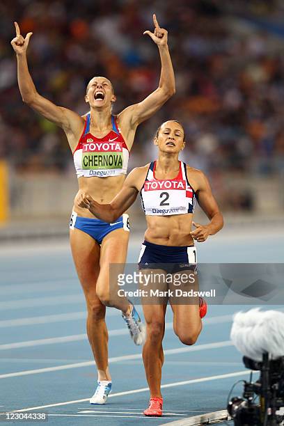 Tatyana Chernova of Russia celebrates claiming gold in the women's heptathlon as Jessica Ennis of Great Britain shows her dejection during day four...