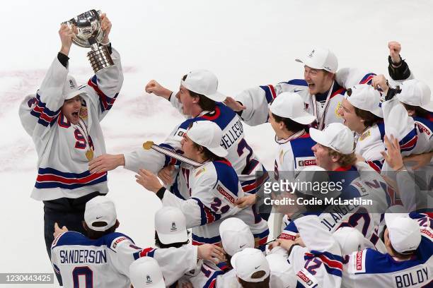 Cam York of the United States hoists the World Junior Championship trophy after beating Canada during the 2021 IIHF World Junior Championship gold...