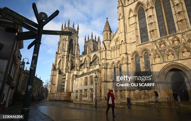 Pedestrian walks on a deserted street outside York Minster in York, north west England on January 6 on the second day of Britain's national lockdown...