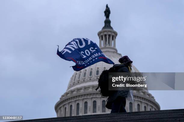 Demonstrator carries a "Trump 2020" flag outside the U.S. Capitol in Washington, D.C., U.S., on Wednesday, Jan. 6, 2021. The House and Senate will...