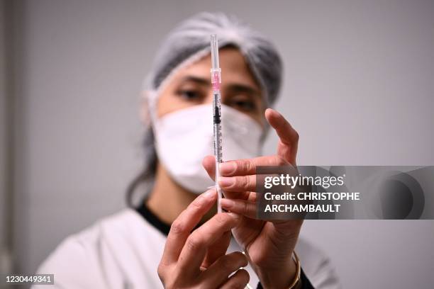 Health worker prepares a syringe with the Pfizer/BioNTech Covid-19 vaccine on January 6 in Aulnay-sous-Bois, as several French medical...