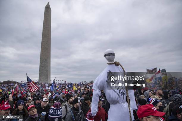 Demonstrator holds a mannequin wearing a noose with "Traitor" written on it during a protest at the Washington Monument in Washington, D.C., U.S., on...