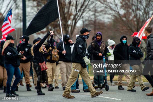Militia like group makes their way to a rally for US President Donald Trump in Washington, DC on January 6 as a total of six buses and about 300...