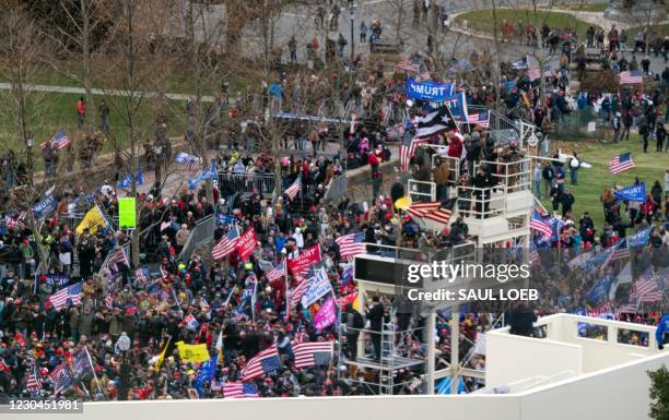 Supporters of US President Donald Trump take over stands set up for the presidential inauguration as they protest at the US Capitol in Washington,...