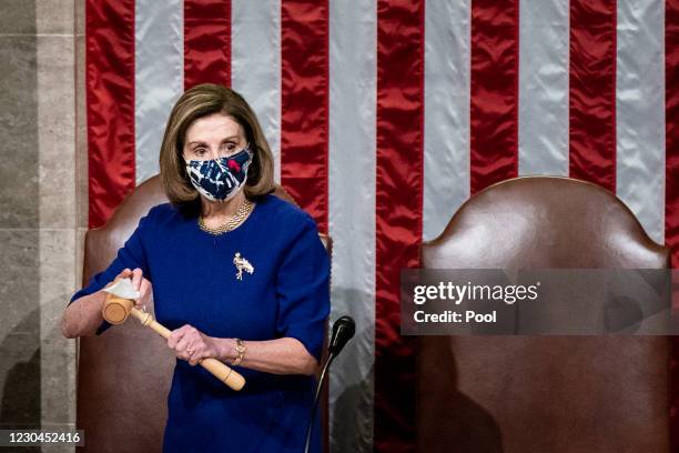 House Speaker Nancy Pelosi sanitizes the gavel after Vice President Mike Pence walked off the dais during a joint session of Congress to certify the...