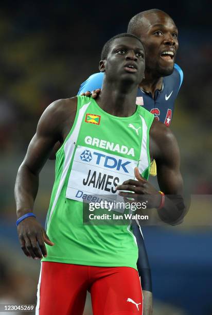 Kirani James of Grenada and LaShawn Merritt of United States look to the scoreboard after finishing the men's 400 metres final during day four of the...