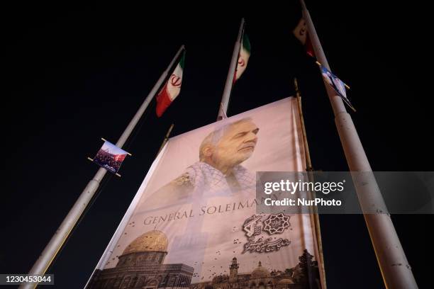 Portrait of the former commander of the IRGC Quds Force, General Qaasem Soleimani is seen on a corner of the Azadi square in western Tehran, during...