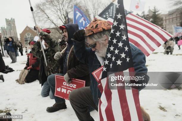 Supporters of President Donald Trump join in a mass prayer out front of the Michigan State Capitol Building to protest the certification of Joe Biden...