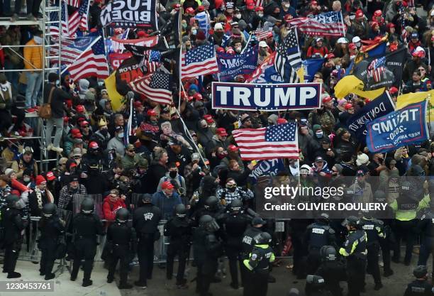 Police hold back supporters of US President Donald Trump as they gather outside the US Capitol's Rotunda on January 6 in Washington, DC. -...