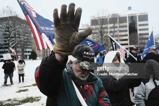 Supporters of President Donald Trump join in a mass prayer out front of the Michigan State Capitol Building to protest the certification of Joe Biden...
