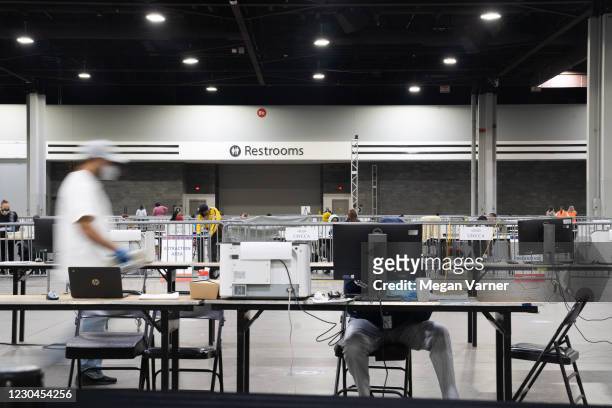 Election officials count votes for Fulton County on January 6, 2021 in Atlanta, Georgia. The polls closed last night at 7pm for the runoff election...