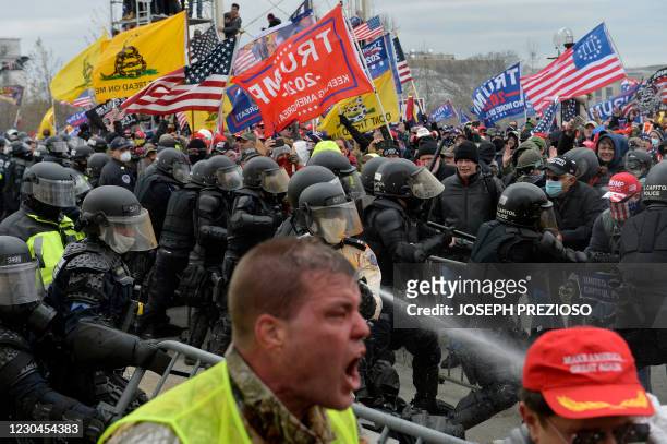 Trump supporters clash with police and security forces as people try to storm the US Capitol in Washington D.C on January 6, 2021. - Demonstrators...