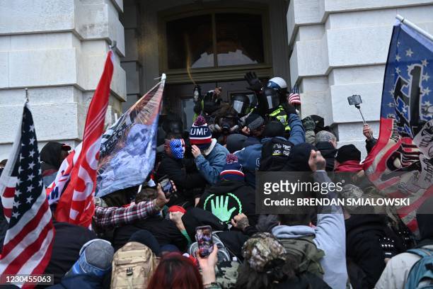 Trump supporters clash with police and security forces as they storm the US Capitol in Washington, DC on January 6, 2021. - Thousands of Trump...