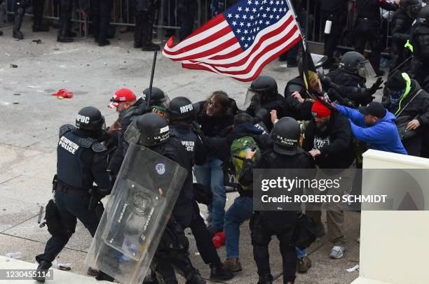 Trump supporters clash with police and security forces as they storm the US Capitol in Washington D.C on January 6, 2021. - Demonstrators breeched...