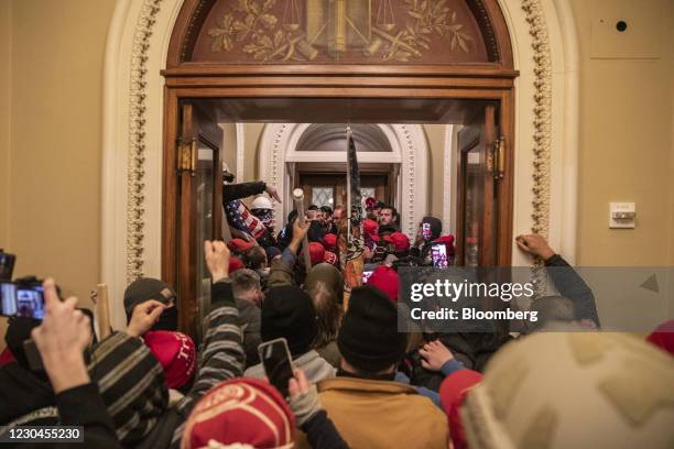 Demonstrators walk through the U.S. Capitol after breaching barricades to the building during a protest outside of in Washington, D.C., U.S., on...