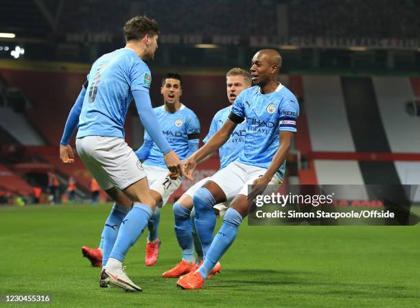 John Stones of Manchester City celebrates scoring the opening goal with Joao Cancelo, Kevin de Bruyne and Fernandinho during the Carabao Cup Semi...