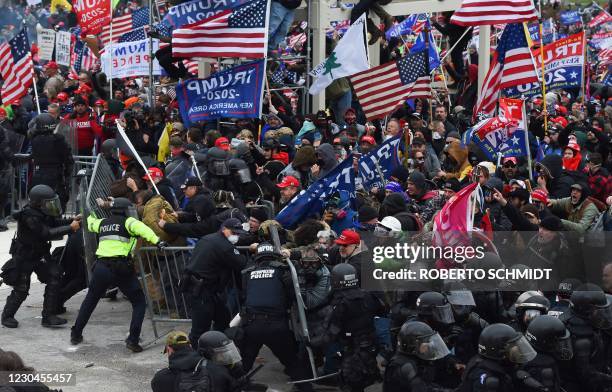 Trump supporters clash with police and security forces as they push barricades to storm the US Capitol in Washington D.C on January 6, 2021. -...