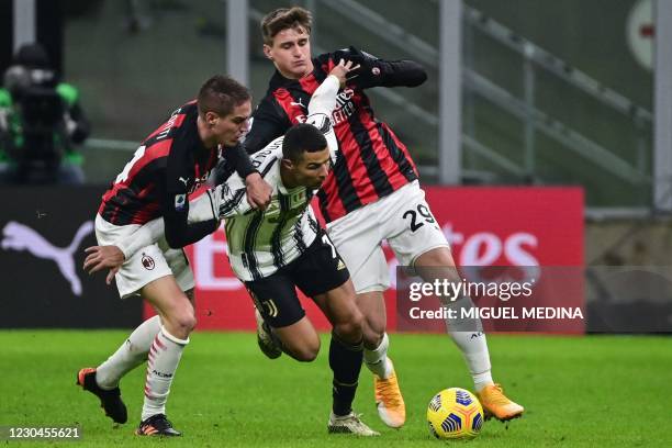 Milan's Italian defender Andrea Conti and AC Milan's Italian forward Lorenzo Colombo tackle Juventus' Portuguese forward Cristiano Ronaldo during the...