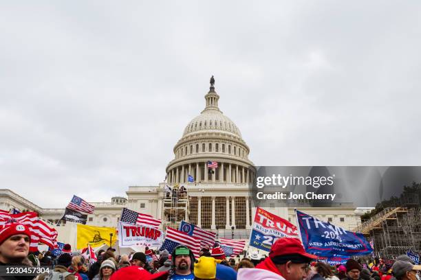 Large group of pro-Trump protesters raise signs and flags on the grounds of the Capitol Building on January 6, 2021 in Washington, DC. A pro-Trump...