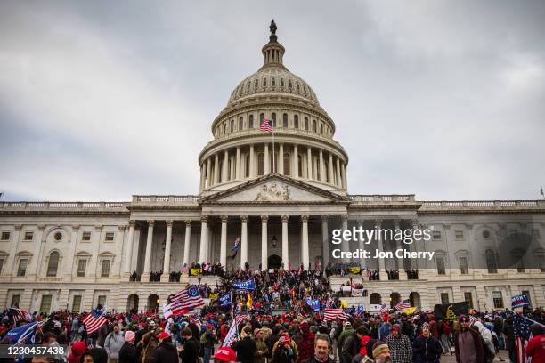 Large group of pro-Trump protesters stand on the East steps of the Capitol Building after storming its grounds on January 6, 2021 in Washington, DC....