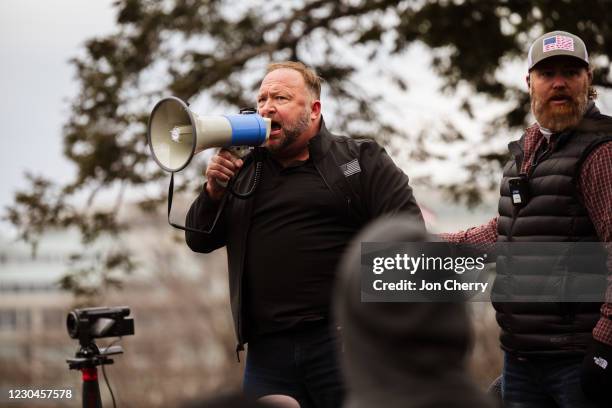 Alex Jones, the founder of right-wing media group Infowars, addresses a crowd of pro-Trump protesters after they storm the grounds of the Capitol...