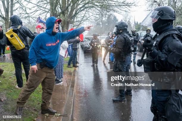 Supporter of President Trump yells at a line of riot police after violence erupted at a protest on January 6, 2021 in Salem, Oregon. Trump supporters...