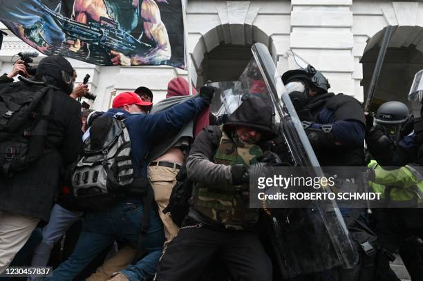 Riot police push back a crowd of supporters of US President Donald Trump after they stormed the Capitol building on January 6, 2021 in Washington,...