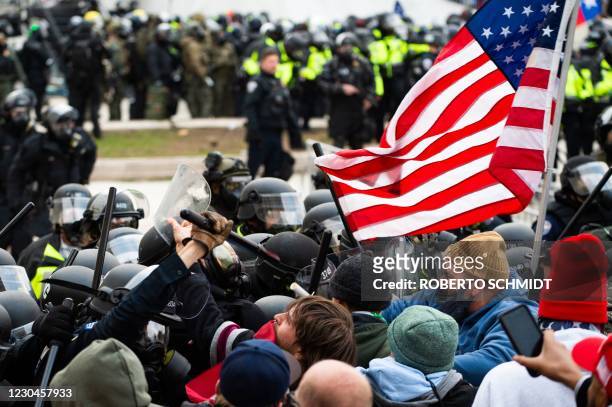 Supporters of US President Donald Trump fight with riot police outside the Capitol building on January 6, 2021 in Washington, DC. - Donald Trump's...