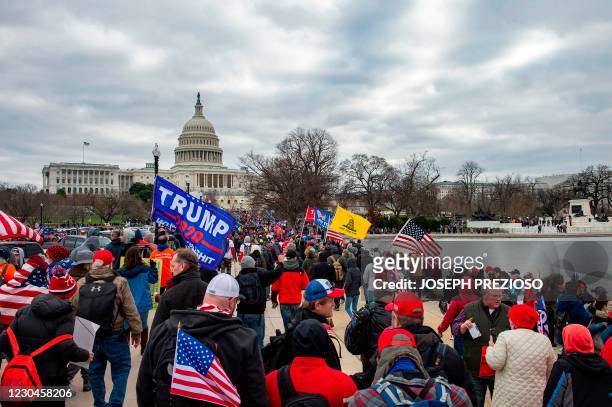 Supporters of US President Donald Trump march through the streets of the city as they make their way to the Capitol Building in Washington DC on...