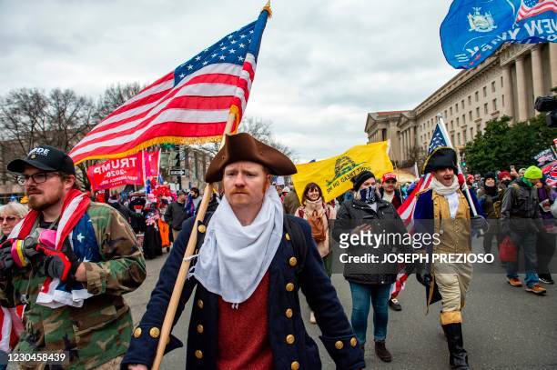 Supporters of US President Donald Trump march through the streets of the city as they make their way to the Capitol Building in Washington DC on...