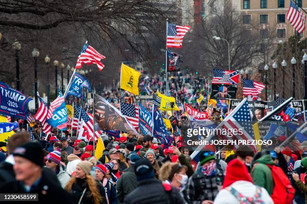 Thousands of supporters of US President Donald Trump march through the streets of the city as they make their way to the Capitol Building in...