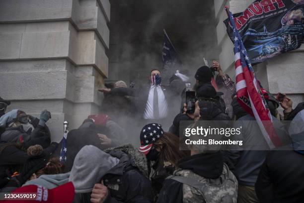 Demonstrators attempt to breach the U.S. Capitol after they earlier stormed the building in Washington, DC, U.S., on Wednesday, Jan. 6, 2021. The...