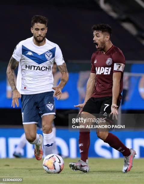 Lanus' Lautaro Acosta reacts next to Velez' Ricardo Alvarez during their Copa Sudamericana all-Argentine semifinal football match at the Jose...
