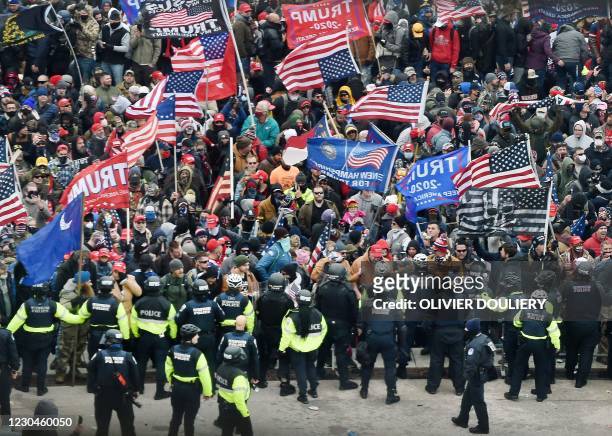 Trump supporters clash with police and security forces as they storm the US Capitol in Washington, DC on January 6, 2021. - Donald Trump's supporters...