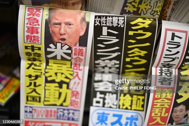 Newspaper front page shows a portrait of US President Donald Trump with the headline of US riot in a convenience store in Tokyo on January 7, 2021. /...