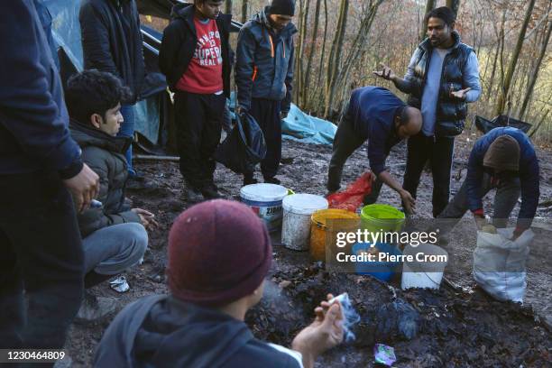 Migrants from Bangladesh are sharing potatoes in a makeshift camp, as group of 50 to 70 migrants from Bangladesh live in a forest near the Croatian...