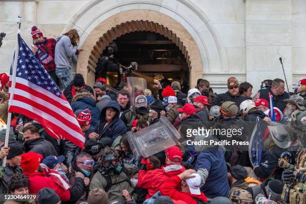 Police use tear gas around Capitol building where pro-Trump supporters riot and breached the Capitol. Rioters broke windows and breached the Capitol...