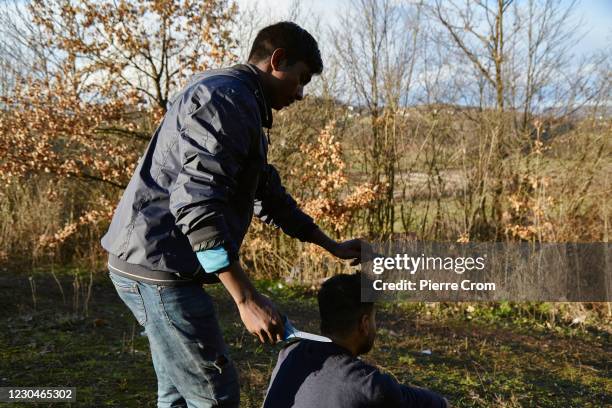 Migrants from Bangladesh are having a haircut, as group of 50 to 70 migrants from Bangladesh live in a forest near the Croatian border on January 7,...