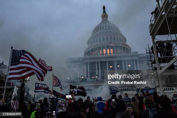 Security forces respond with tear gas after the US President Donald Trump's supporters breached the US Capitol security. Pro-Trump rioters stormed...