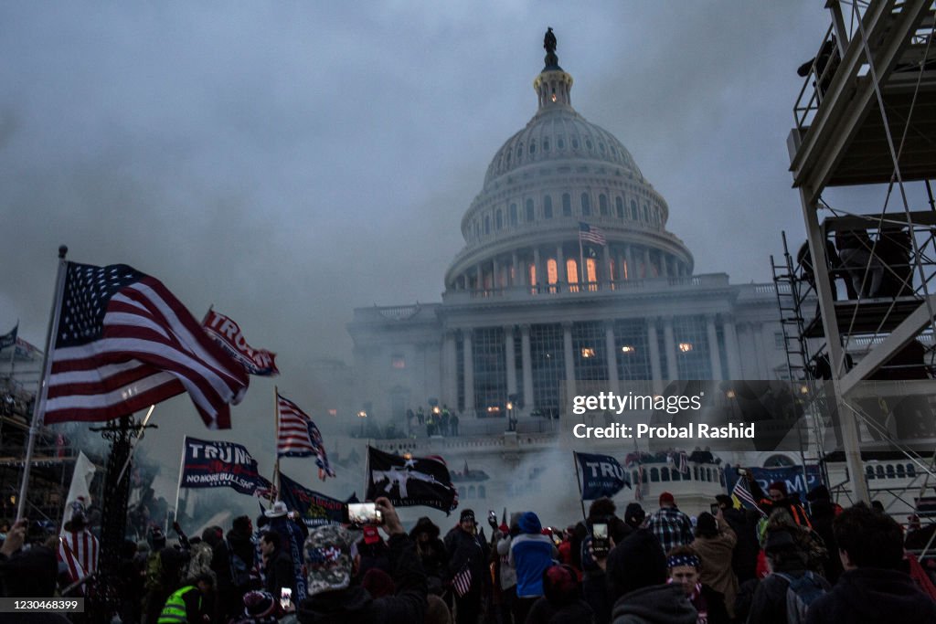 Security forces respond with tear gas after the US President...