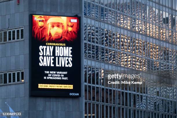 Large scale HM Government, and NHS advertising board advice to stay at home and help save lives during the third national coronavirus lockdown in...