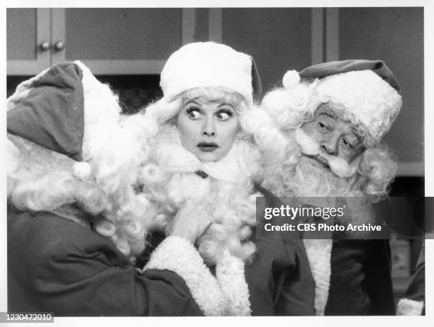 Actress Lucille Ball and fellow cast members, dressed in Santa Claus outfits, in the December 24, 1956 broadcast of the" I Love Lucy Christmas...