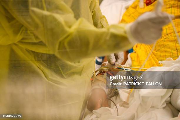 Nurse wearing personal protective equipment attends to a patient in a Covid-19 intensive care unit at Martin Luther King Jr. Community Hospital on...