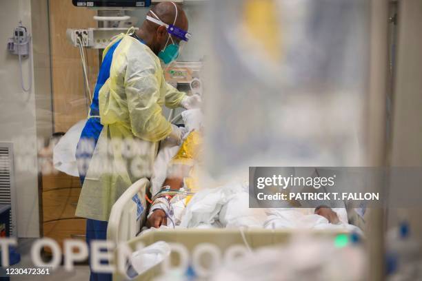 Nurses wearing personal protective equipment attend to patients in a Covid-19 intensive care unit at Martin Luther King Jr. Community Hospital on...