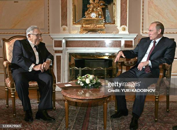 Russian President Vladimir Putin meets with former US Secretary of State Henry Kissinger during their meeting at the Kremlin in Moscow 12 February...