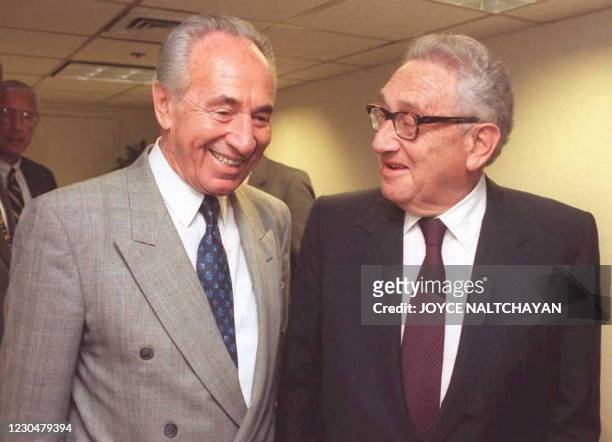 Israeli Foreign Minister Shimon Peres is greeted by Henry Kissinger, former US Secretary of State, before addressing the Center for Strategic and...