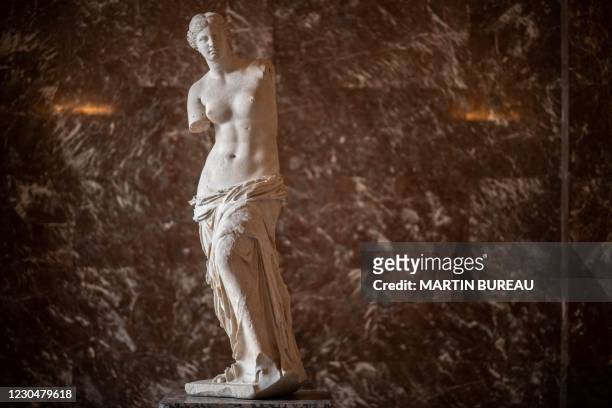 Picture taken on January 8, 2021 at the Louvre Museum in Paris shows the Venus of Milo sculpture in an empty hall, as the Museum remains closed due...